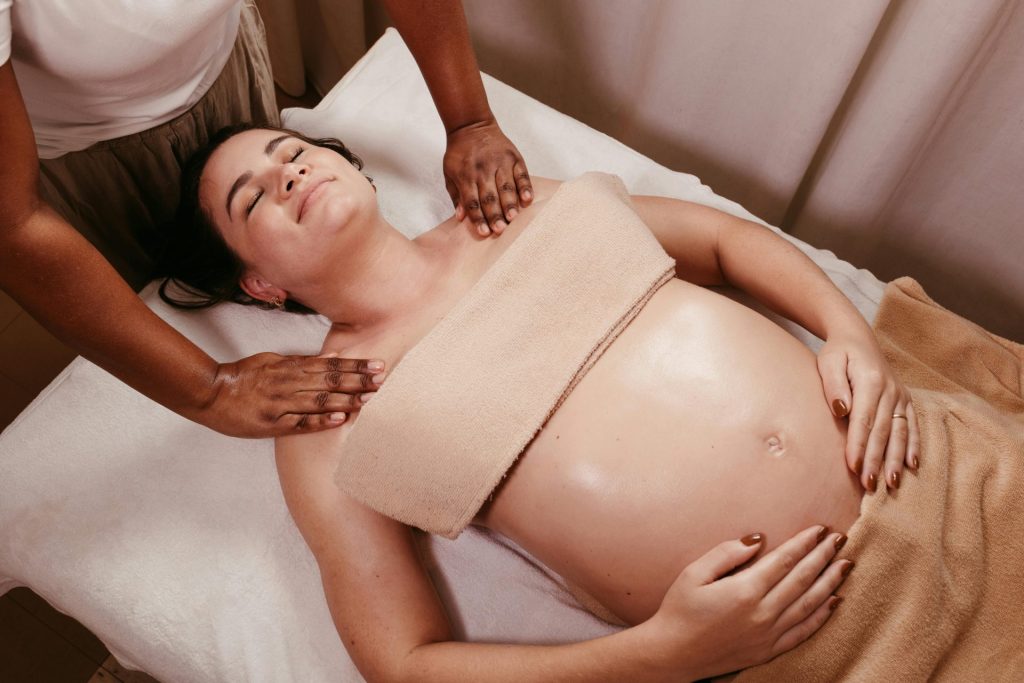 Pregnant woman receiving a relaxing massage.