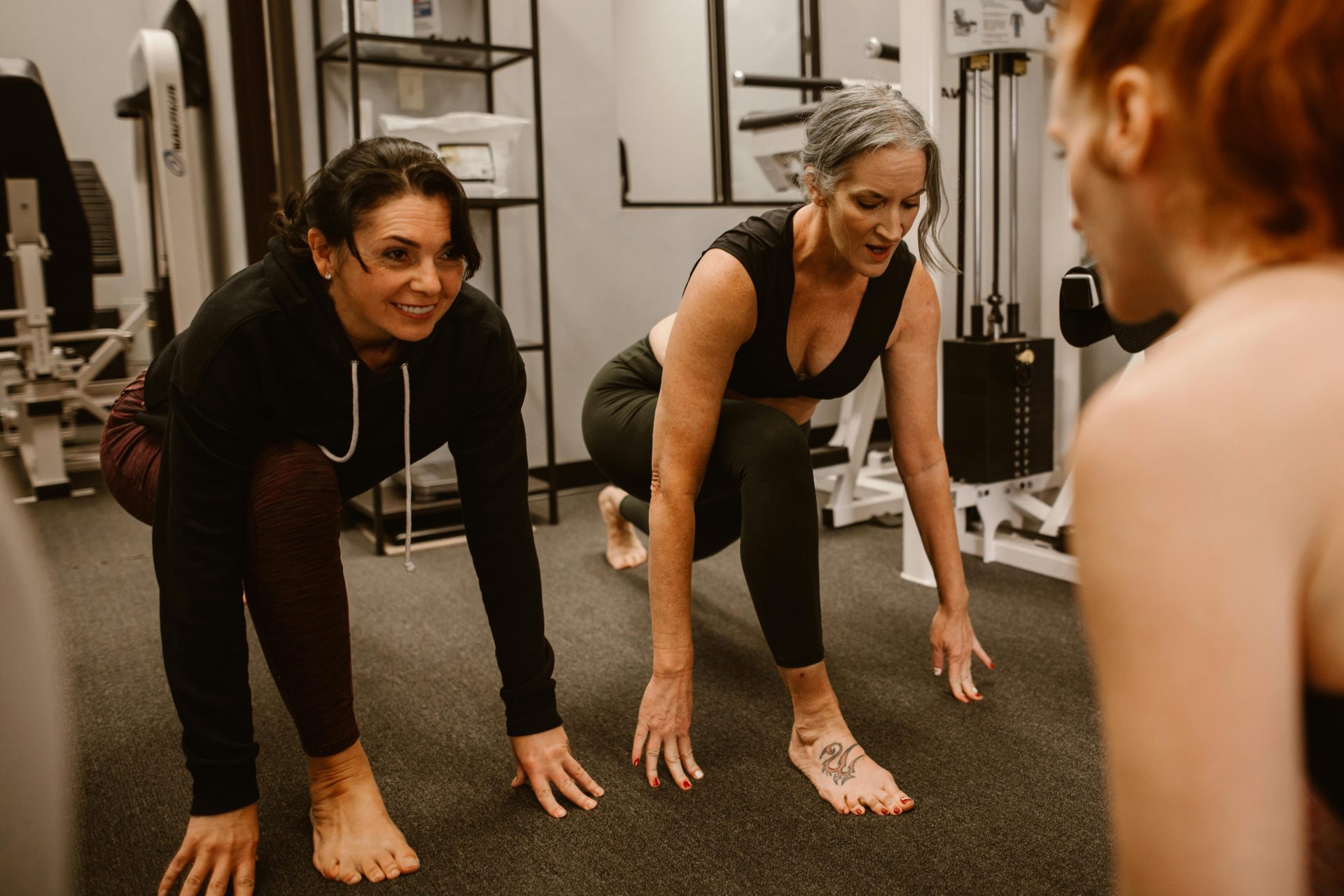 Two women stretching during fitness training.