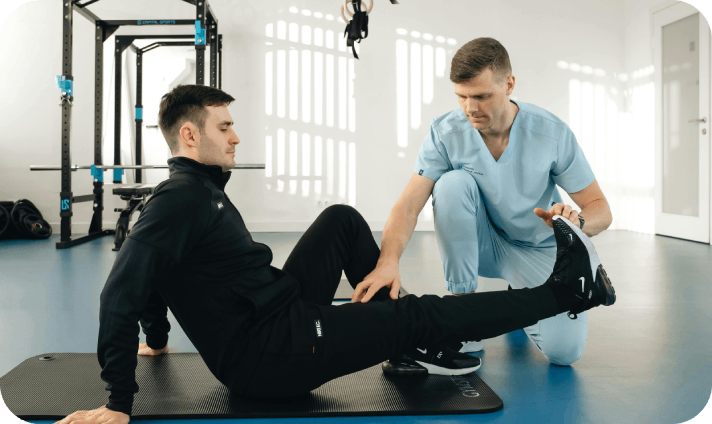 Physical therapist guiding leg rehabilitation exercise.